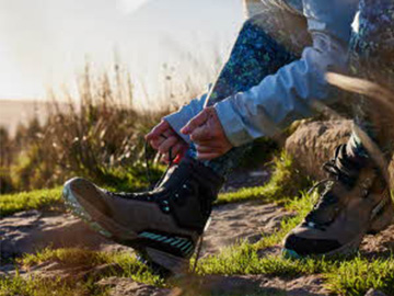Woman lacing up hiking boots
