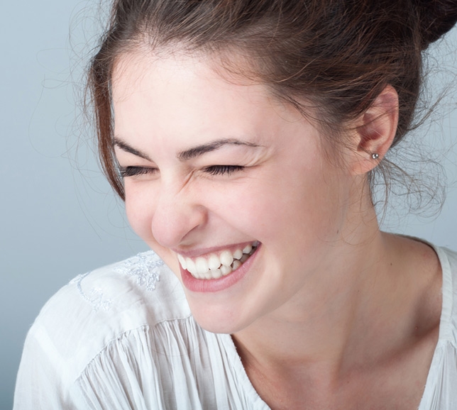 Woman wearing a white t-shirt and smiling