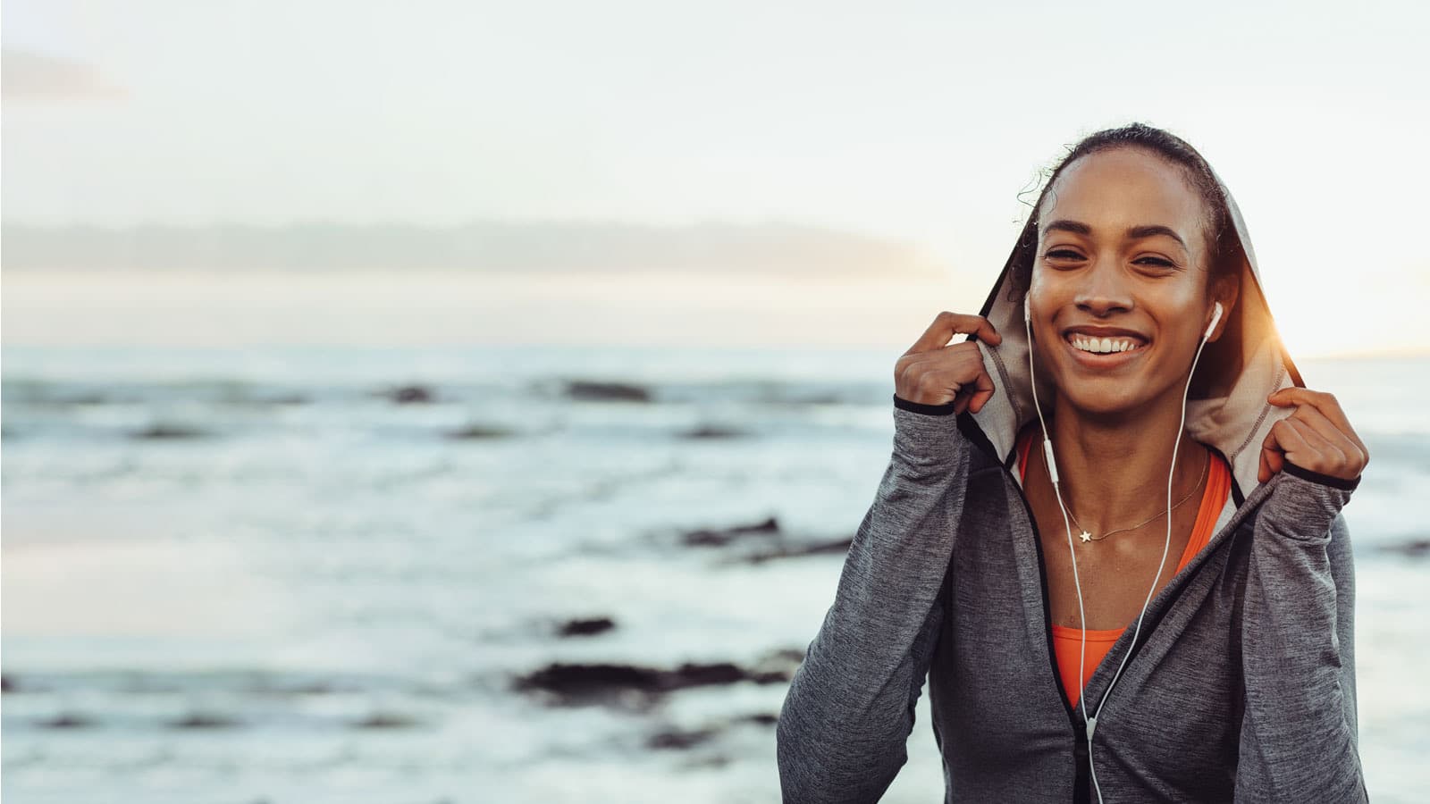 smiling woman next to the sea