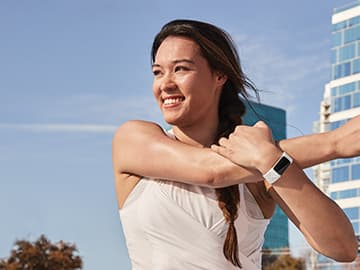 Lady stretching with fitbit on wrist