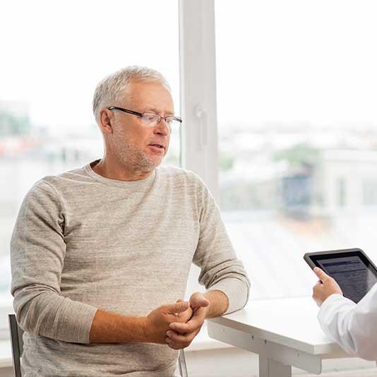 Older man talking to a doctor