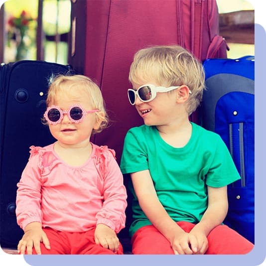 Baby sister and brother on holiday wearing sunglasses