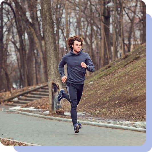 Man running fast on path through woods