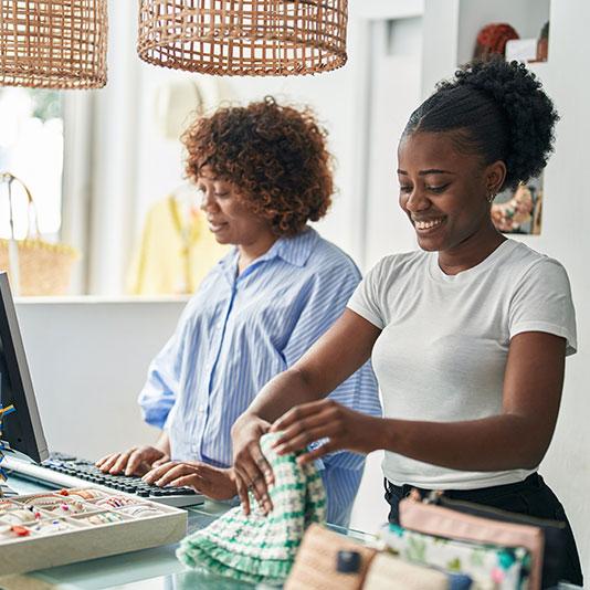 Two women working behind a counter in a shop