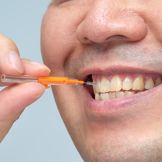 Man using interdental brush