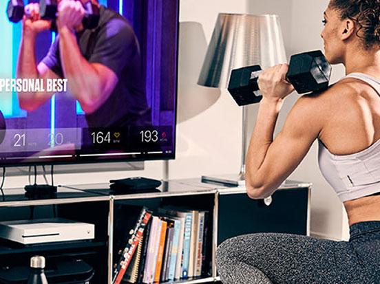 Woman working out with dumbells at home