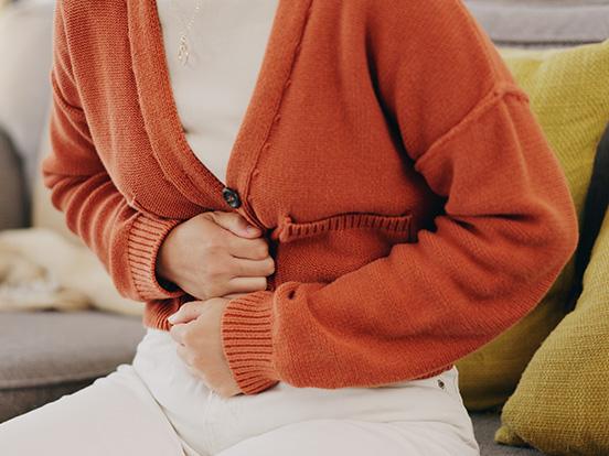 Woman holding her stomach in pain