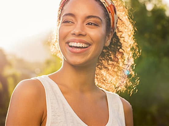 Woman wearing headband smiling in the sunshine